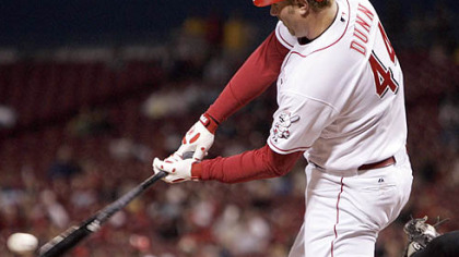 The Reds' Adam Dunn hits a three-run home run off Pirates starter Ian Snell in the fifth inning last night in Cincinnati.