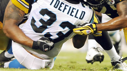 LaMarr Woodley, left, Lawrence Timmons and Ryan Clark gang up on Carolina's LaBrandon Toefield in the first quarter last night at Heinz Field.