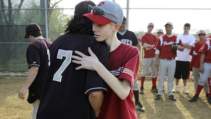 John Challis gets a hug from Beaver's Al Torrence after the two teams played on April 24.