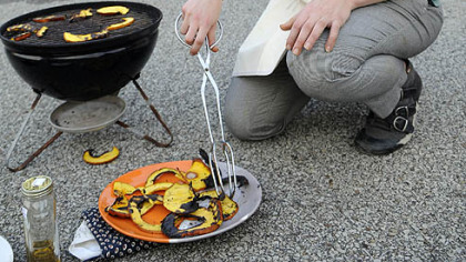 Laura Miller prepares Grilled Pumpkin in a parking lot on Butler Street in Lawrenceville.