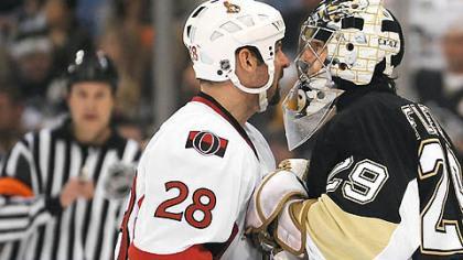 Marc-Andre Fleury goes face-to-face with the Senators' Martin Lapointe in the second period at the Mellon Arena last night.