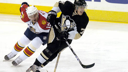 Evgeni Malkin gets around Florida's Jozef Stumpel. Malkin scored his eighth goal in the past eight games.