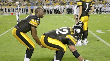 Justin Hartwig (62) warms up with quarterback Dennis Dixon before the first preseason game. Hartwig, signed as a free agent in the offseason, will be the starting center this season.