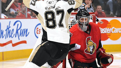 Sidney Crosby celebrates his third-period goal in front of Senators goalie Martin Gerber last night at Scotiabank Place in Ottawa.
