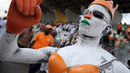ABIDJAN, Ivory Coast -- A fan of the national soccer team poses at the Champroux de Marcory stadium match against Madagascar. Ivory Coast won 3 -0.
