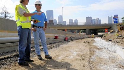 Teacher Norma McGinnis talks construction last week with Gary Chesnoski, project supterintendent of the Route 28/Interstate 279 connector project on the North Side.