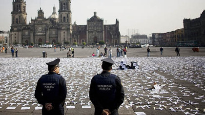 MEXICO CITY -- Police stand next to crosses displayed at the main square outside the Presidential Palace during a protest against the law that legalized abortion. Mexico's Supreme Court indicated it will uphold a city law allowing abortion that has divided the country.
