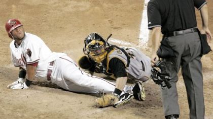Arizona's Alex Romero, left, looks to home-plate umpire Angel Campos for the call as catcher Ryan Doumit makes the tag in the sixth inning. Romero was out on the play.