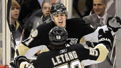 The Penguins' Evgeni Malkin celebrates his first period goal with teammate Kris Letang last night.