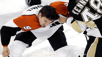 Flyers' Tyler Kennedy fights Flyers Scottie Upshall in the first period Sunday.