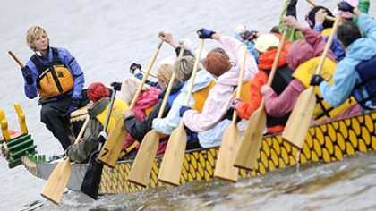 Lynne Franks-Meinert, president of the Steel City Dragons, beats the cadence for the paddlers of Pink Steel, a dragon boat crew comprised of breast cancer survivors. The women say dragon boat racing has improved their health and their outlook on life.