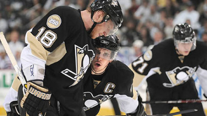 Sidney Crosby talks with Marian Hossa.