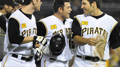The Pirates' Freddy Sanchez, center, is congratulated by Jason Bay, left, and Xavier Nady, right, after Sanchez hit a game-winning single in the bottom of the ninth inning of last night's game to give the Pirates a 3-2 victory over the Atlanta Braves at PNC Park.