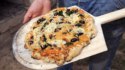 A Garlic, Spinach and olive pizza baked in Braddock's community bread oven.