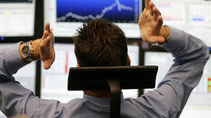 FRANKFURT -- A broker reacts to the soaring stock market, Monday, Oct. 13.