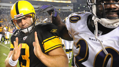 Jeff Reed, left, shows Baltimore's Ed Reed how close his winning kick in overtime was to the upright. The kick helped Reed earn AFC special teams player of the week.