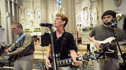 Josh Gawaldo, center, a Duquesne University music student, will play for World Youth Day with Pope Benedict XVI in Australia this month.  Here he plays with Eric Campbell, left, and Carl Stuvek, right, members of the Music Ministry at St. Paul Cathedral in Oakland.