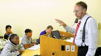 Students in a business lecture class at La Roche College listen to Lance Shaeffer, right, give instructions on an upcoming exam.