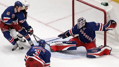 New York Rangers goalie Henrik Lundqvist, right, blocks a shot on the goal from the Penguins' Sidney Crosby as he is defended by teammate  Marc Staal (18)  as Michal Rozsival (3), looks on during tonight's Game 4 of their second-round playoff series.