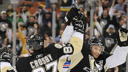 Penguins Sidney Crosby and Petr Sykora celebrate after assisting on goal by Sergei Gonchar in the first period against the Rangers last night at Mellon Arena.