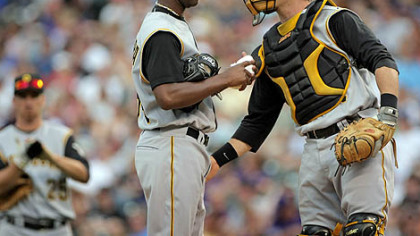 Catcher Ryan Doumit offers some encouragement to starter Yoslan Herrera in the first inning last night at Coors Field. Herrera failed to make it out of the second inning.