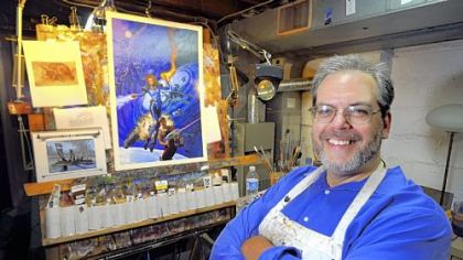 Christopher Moeller, a graphic novel artist, in his basement studio in Mt. Lebanon, with a White Wolf Games illustration "Aberrant."