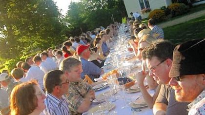 Diners crowd the long table at Outstanding in the Field's dinner at Kinnikinnick Farm in Caledonia, Ill., last Aug. 25.