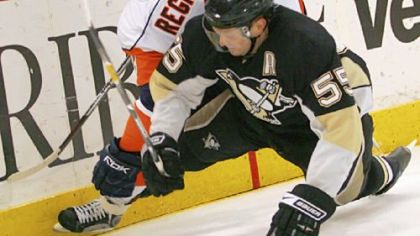 Defenseman Sergei Gonchar battles for the puck with the Islanders' Steve Regier in the Penguins' 3-1 win March 27 at Mellon Arena. The defense has developed into a reliable group as it prepares for next week's playoffs.