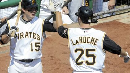 Pirates' Adam LaRoche gets a high five from his brother, Andy, after hitting a tying two-run home run in the sixth inning.