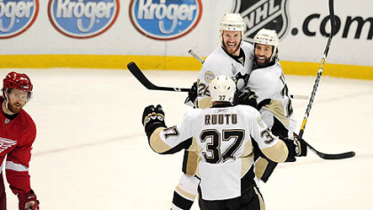 Penguins winger Adam Hall celebrates with teammates Maxime Talbot and Jarkko Ruutu after scoring his team's second goal Monday night.