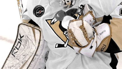 Penguins goalie Marc-Andre Fleury juggles the puck as he makes a third-period save against the New Jersey Devils last night. Fleury stopped all 31 Devils shots in the Penguins' 2-0 win.