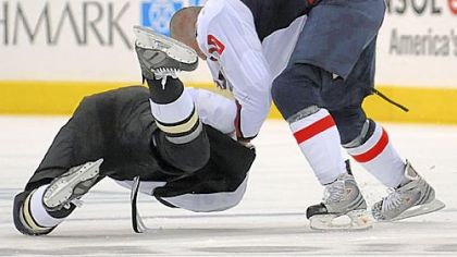 The Penguins' Paul Bissonnette is taken down by the Capitals' Matt Bradley in a second-period scuffle last night.