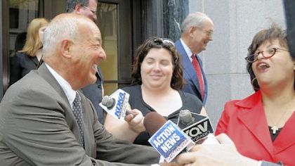 Former Allegheny County Coroner Dr. Cyril H. Wecht, left, jokes with reporters after arguments about whether Dr. Wecht should be retried were made before the 3rd U.S. Circuit Court of Appeals.