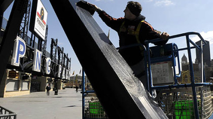 Paul Rossi, of the North Side and with A.N.S.Inc., sponges down part of the superstructure of PNC Park yesterday as part of the cleanup for the Pirates' home opener on Monday. He said that the whole superstructure is cleaned as well as the glass.