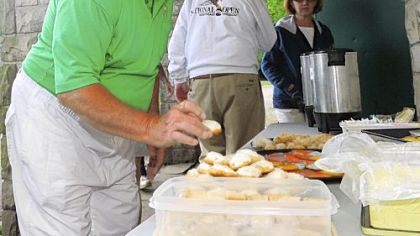 Hank Luba, president of the Frick Park Lawn Bowling Club, samples cookies baked by members during a Wednesday night lawn bowling match and cookie fest.