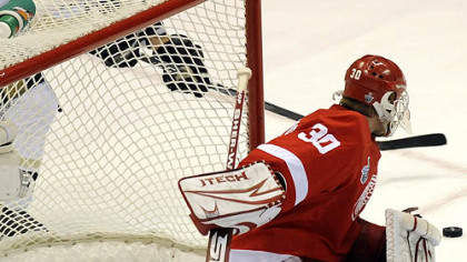 Penguins center Maxime Talbot reaches to shoot the tying goal against the Red Wings in the third period.