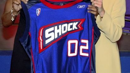 Swin Cash, left, when was chosen as the No. 2 pick in the WNBA draft by the Detroit Shock in 2002. WNBA President Val Ackerman presents her with the Shock jersey.