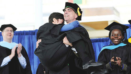 To a rousing ovation, Randy Pausch carries his wife, Jai back to their seats after giving the charge to the graduates at CMU's 111th commencement ceremony May 18.