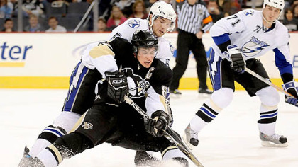 Sidney Crosby is taken down by the Lightning's Paul Ranger before crashing in to the boards in the first period. Crosby left the game with a high ankle sprain.