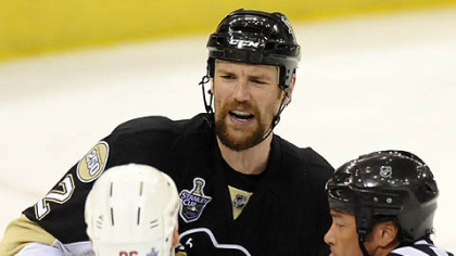 The Penguins' Hal Gill and the Red Wings' Tomas Holmstrom get seperated in the second period.