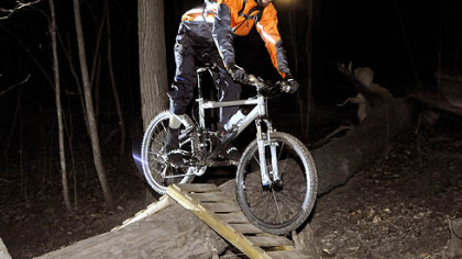 Jared Musser, 26, a civil engineer, pedals over a ramp on the Nature Trail in Frick Park. He began night riding in 2002, when he bought his first headlight.