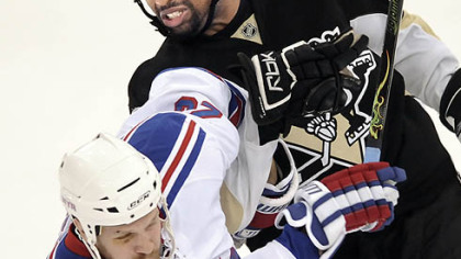 The Penguins' Georges Laraque gets tied up with the New York Rangers' Fredrik Sjostrom in a playoff game.  
When it comes to helping community groups, the Penguins' strongman says, "there are no bad charities."