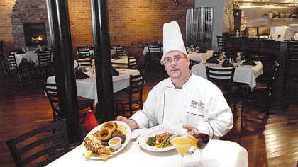 Chef and owner Matt Mantini serves up grilled Alaskan Halibut with pico de gallo and grilled T-bone steak with grilled lobster tail at Mantini's new location on the South Side.