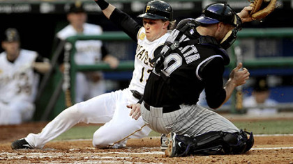 Nate McLouth begins the Pirates' rally, scoring in the third inning.