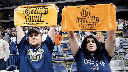 Eric Zdenek, 29, and his girlfriend, Lisa Luca, 26, of Emsworth, show their respect for Myron Cope at the start of the Pitt game last night.