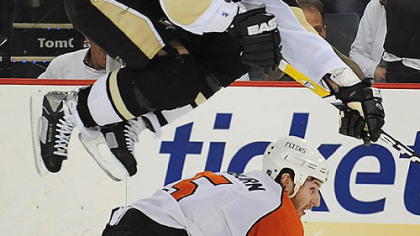The Penguins' Ryan Malone jumps over the Flyers' Braydon Coburn at the Mellon Arena last night.