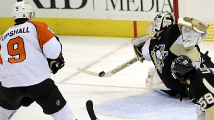Penguins Marc-Andre Fleury makes a save on Flyers Scottie Upshall late in the third period Sunday.
