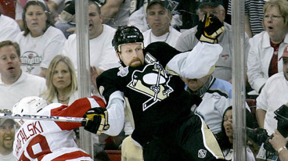 Detroit Red Wings defenseman Brian Rafalski (28) checks Penguins forward Gary Roberts, right,  into the boards during the second period in Game 3 of the Stanley Cup hockey final at Mellon Arena.