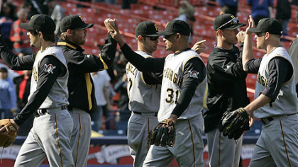 Chris Gomez, left, Luis Rivas, center, and relief pitcher Evan Meek, right celebrate with teammates after beating the New York Mets, 13-1 Wednesday.