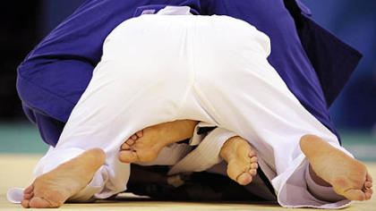 Cuba's Driulis Gonzalez, blue, and Taiwan's Chin-Fang Wang compete during their 63kg judo match.